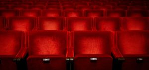 Red seats in auditorium in theatre