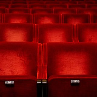 Red seats in auditorium in theatre