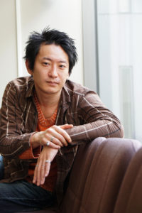 headshot of a Japanese theatre director Kenichi Tani