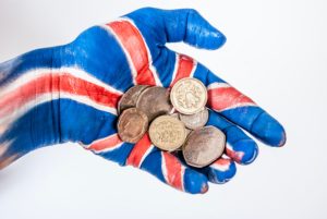 Grabbing UK coins in a hand
