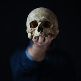 holding a skull in his hand