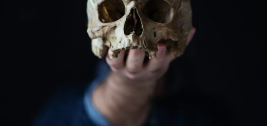 holding a skull in his hand