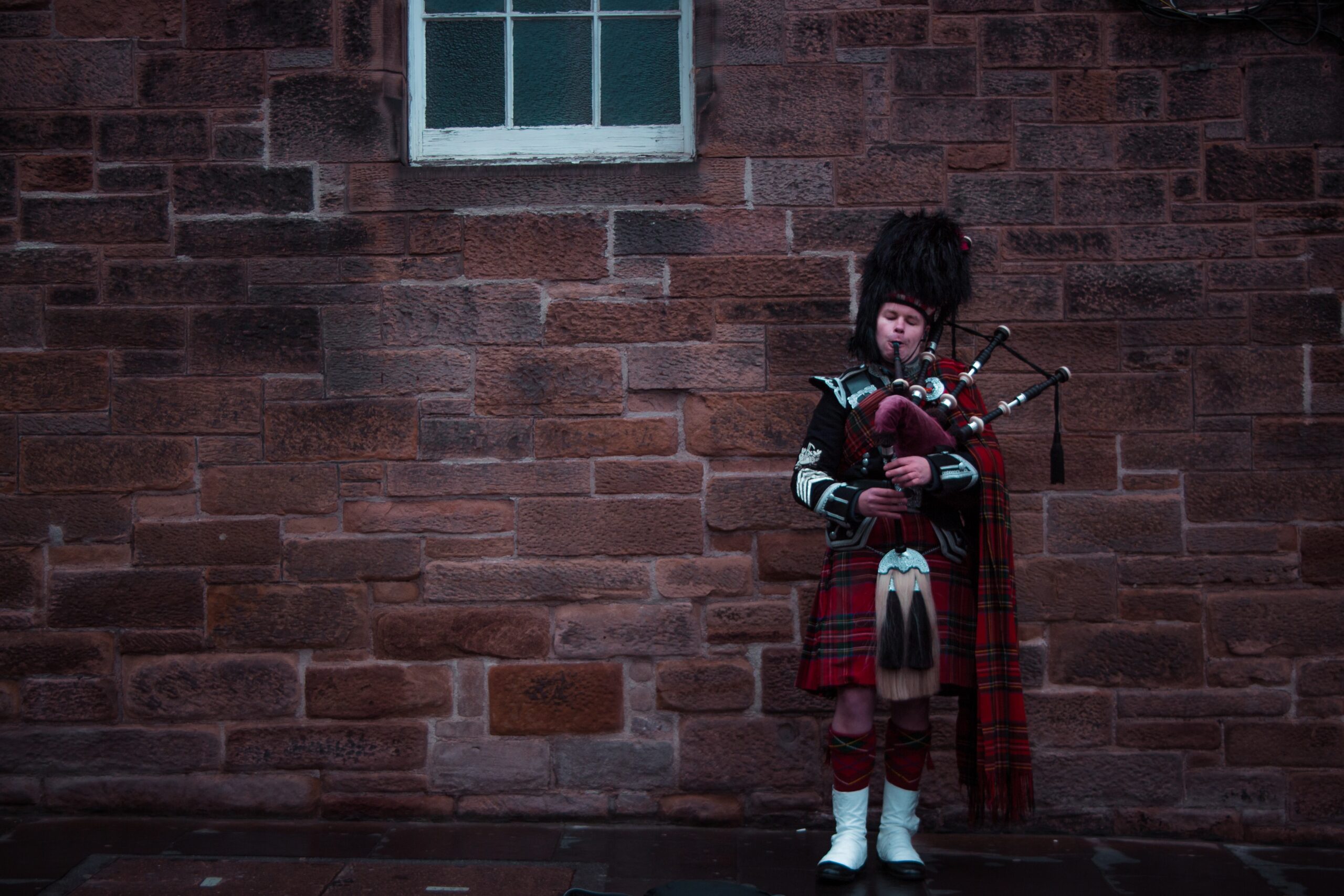 A man playing bagpipes in Edinburgh